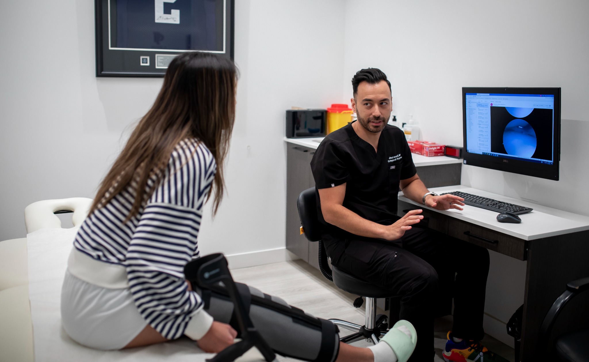 Dr. Abouali speaking with a patient during a consultation
